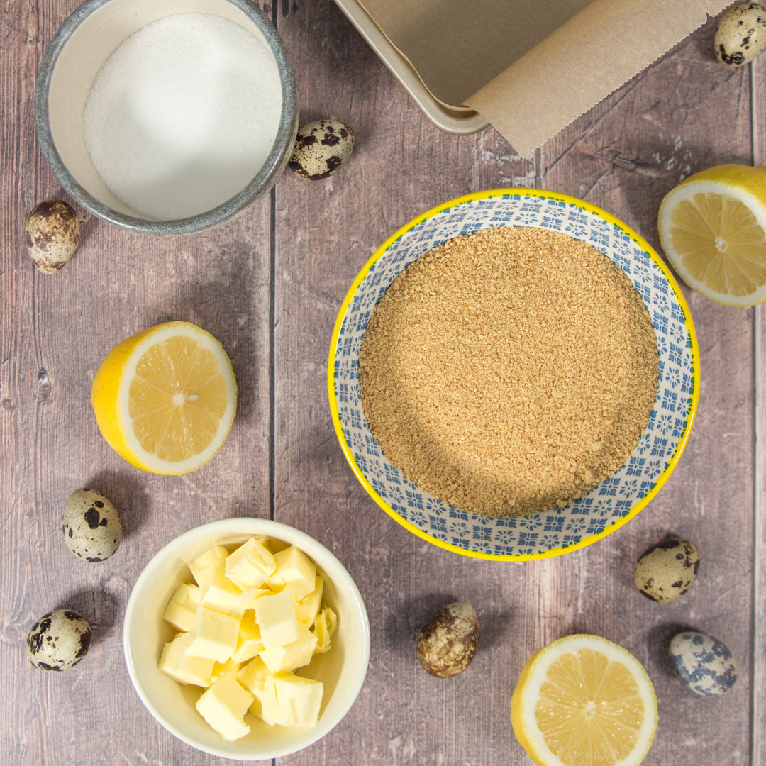 butter, graham cracker crumbs, sugar in bowls and lemons