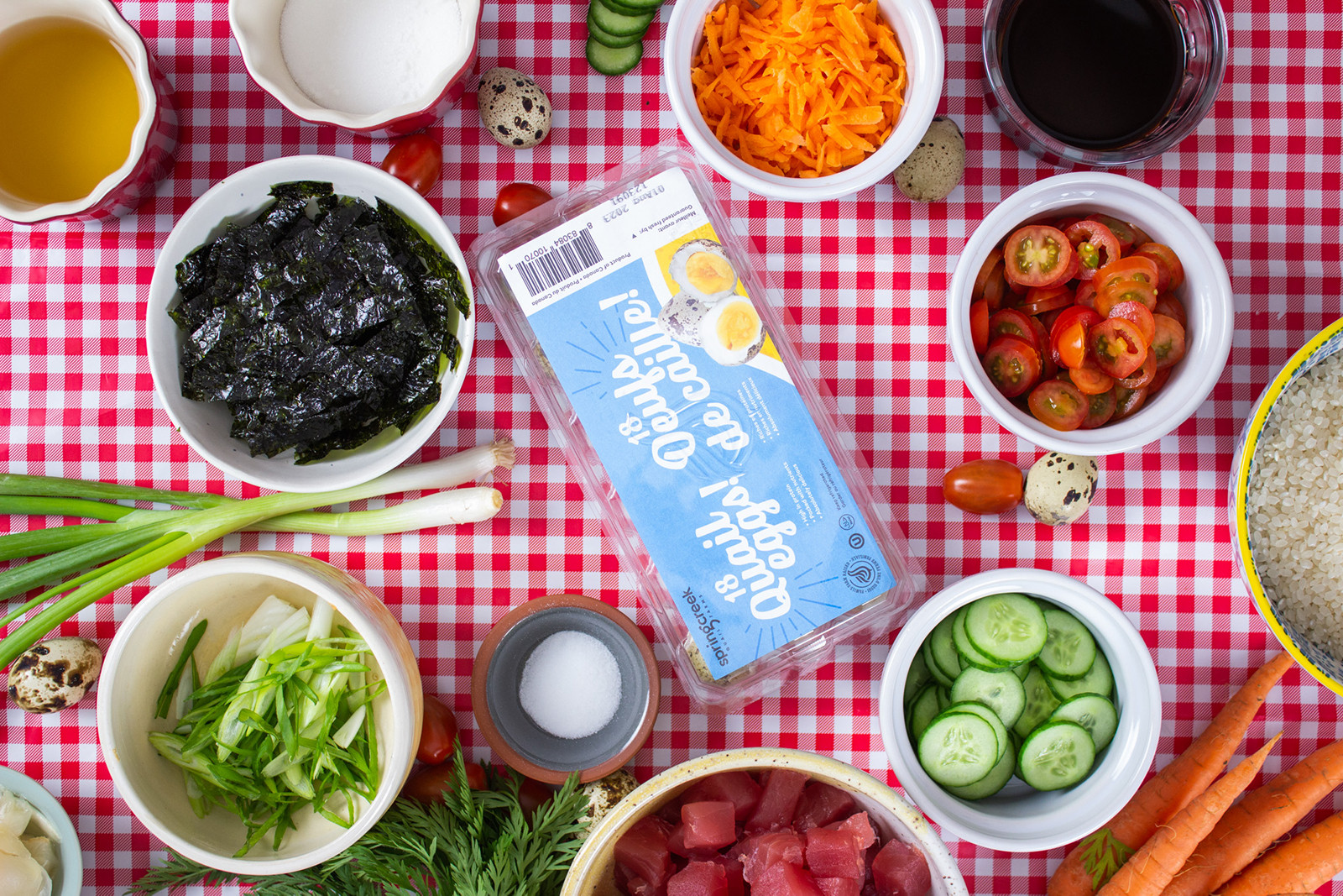 veggie ingredients and quail eggs on plaid table cloth