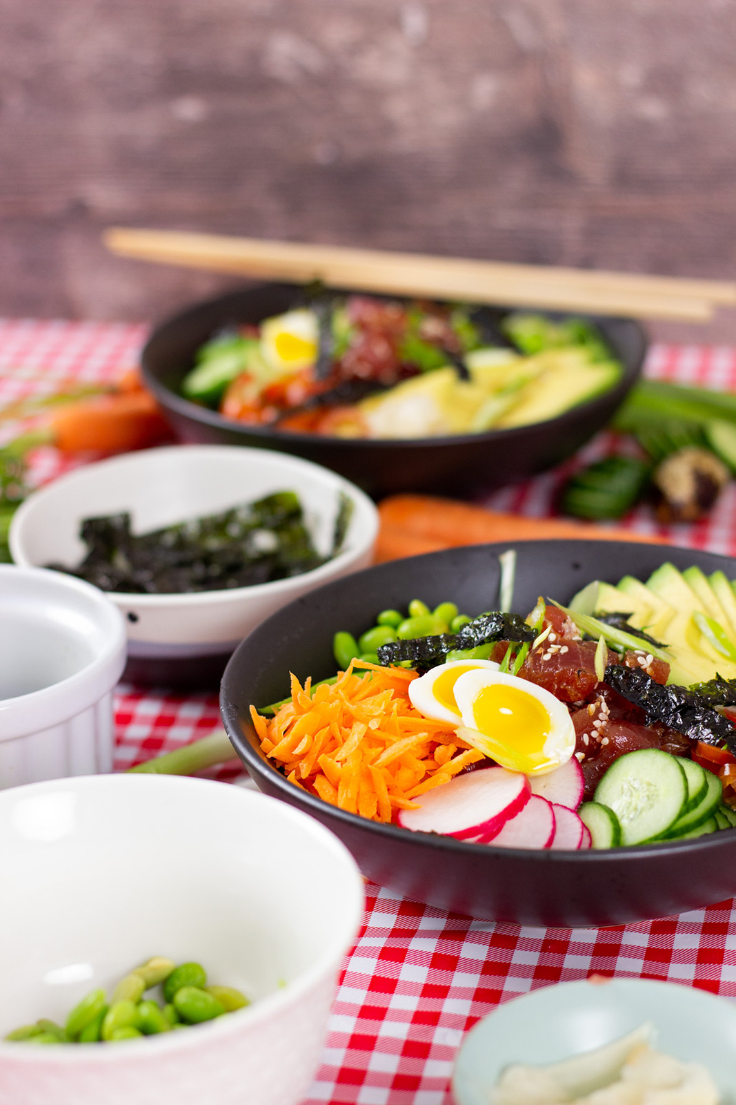 veggie ingredients and quail eggs on plaid table cloth