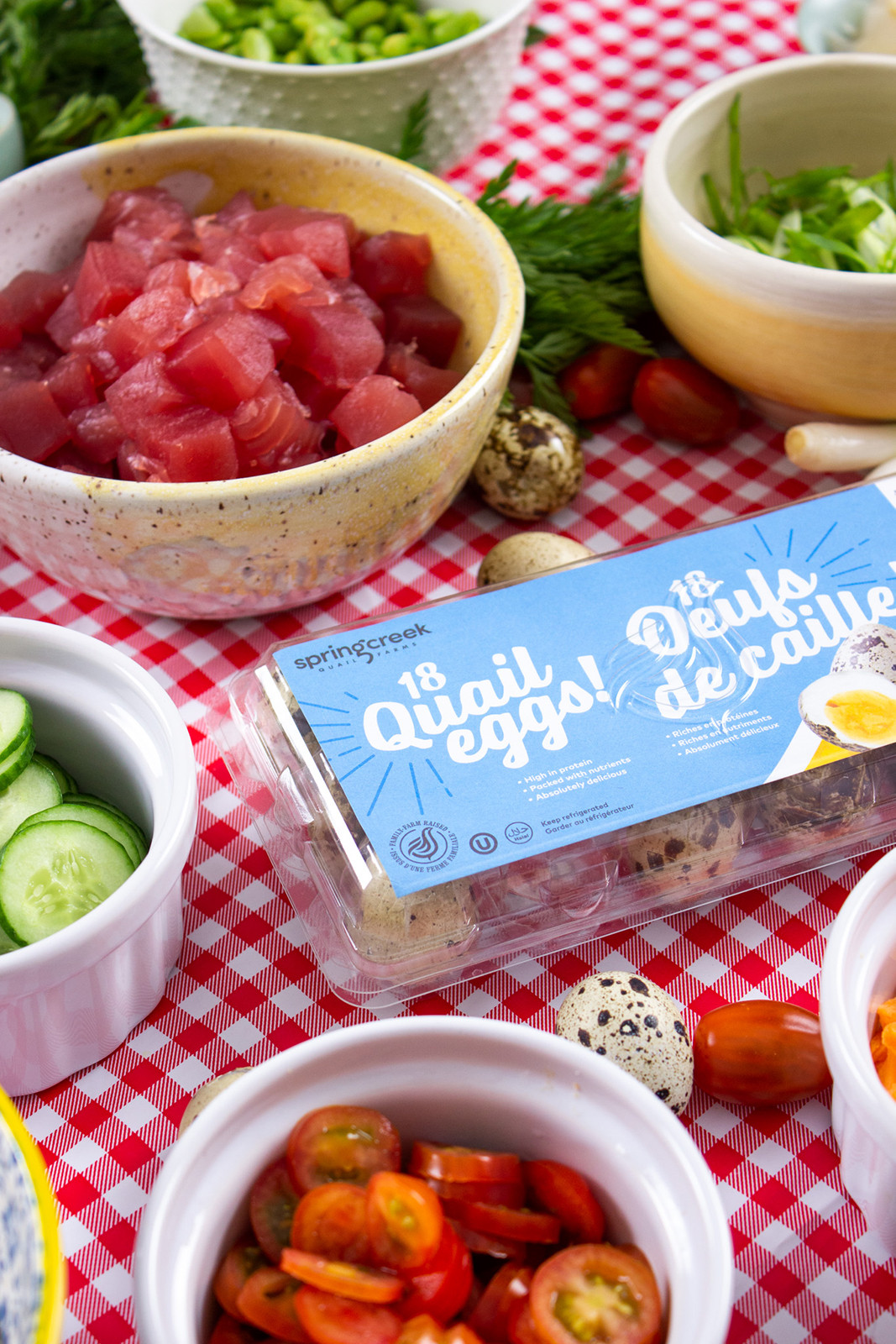 veggie ingredients and quail eggs on plaid table cloth