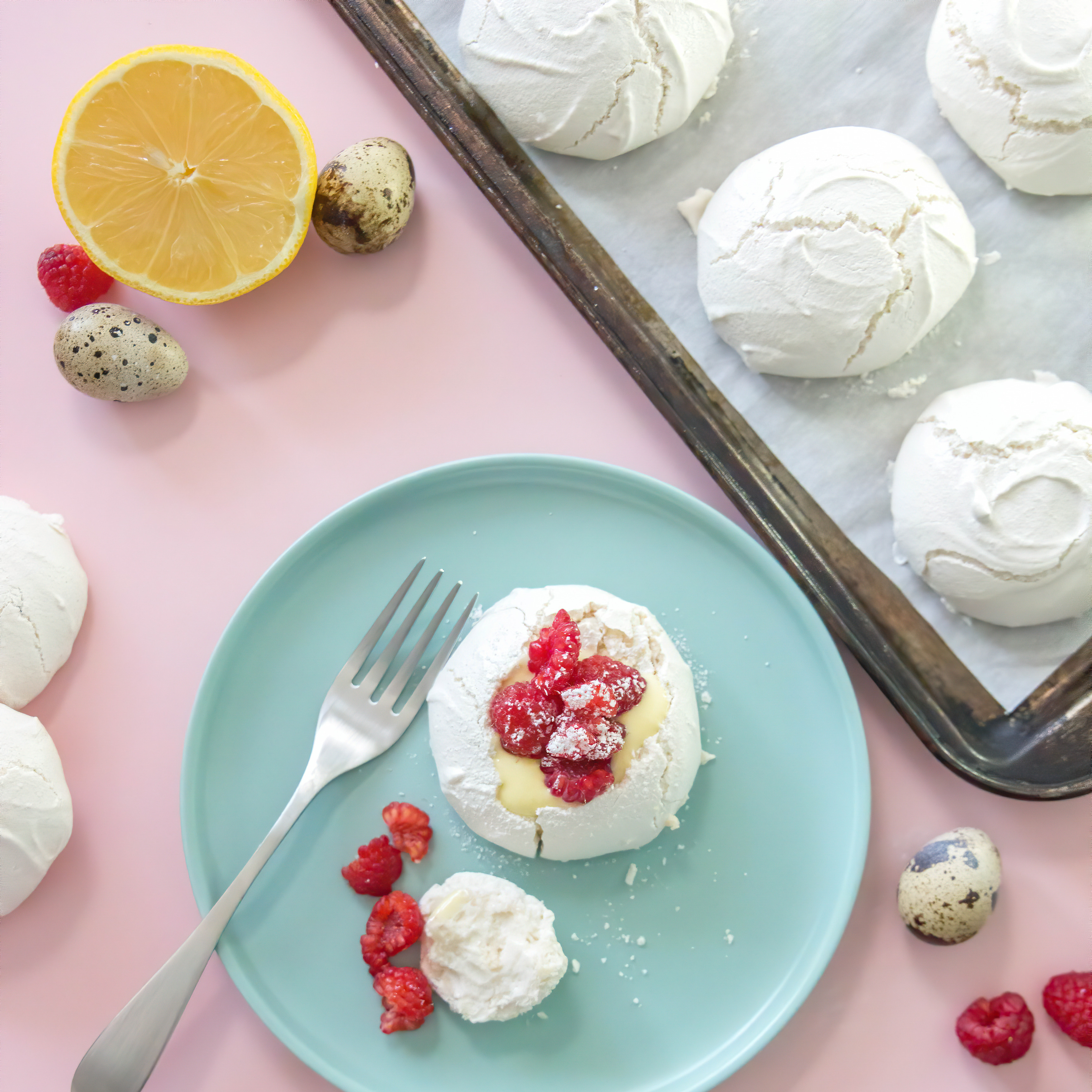Raspberry Pavlovas With Lemon Curd  and lemons